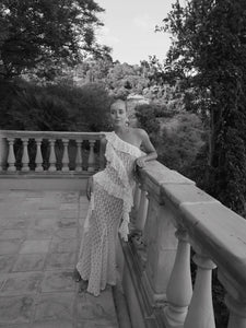 Elevate your wardrobe with the Asymmetric Lace Set, designed for those who appreciate refined elegance. The high-waisted semi-sheer long skirt ensures a comfortable fit thanks to its elastic waistband, while the semi-sheer top features an asymmetric neckline and delicate ruffle accents that add a sophisticated edge. This ensemble seamlessly blends subtle allure with comfort, making it an ideal choice for sophisticated occasions where impeccable style is paramount.