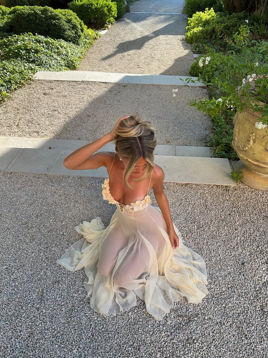 The Valentina Dress is crafted from delicate silk chiffon and features intricately handcrafted floral detailing individually positioned on the bust, creating a uniquely elegant motif. Its 1/8-inch chiffon crisscross straps add refined support and visual interest at the center. Designed with a separate full lining, it offers versatile wear options, either sheer or fully lined. 