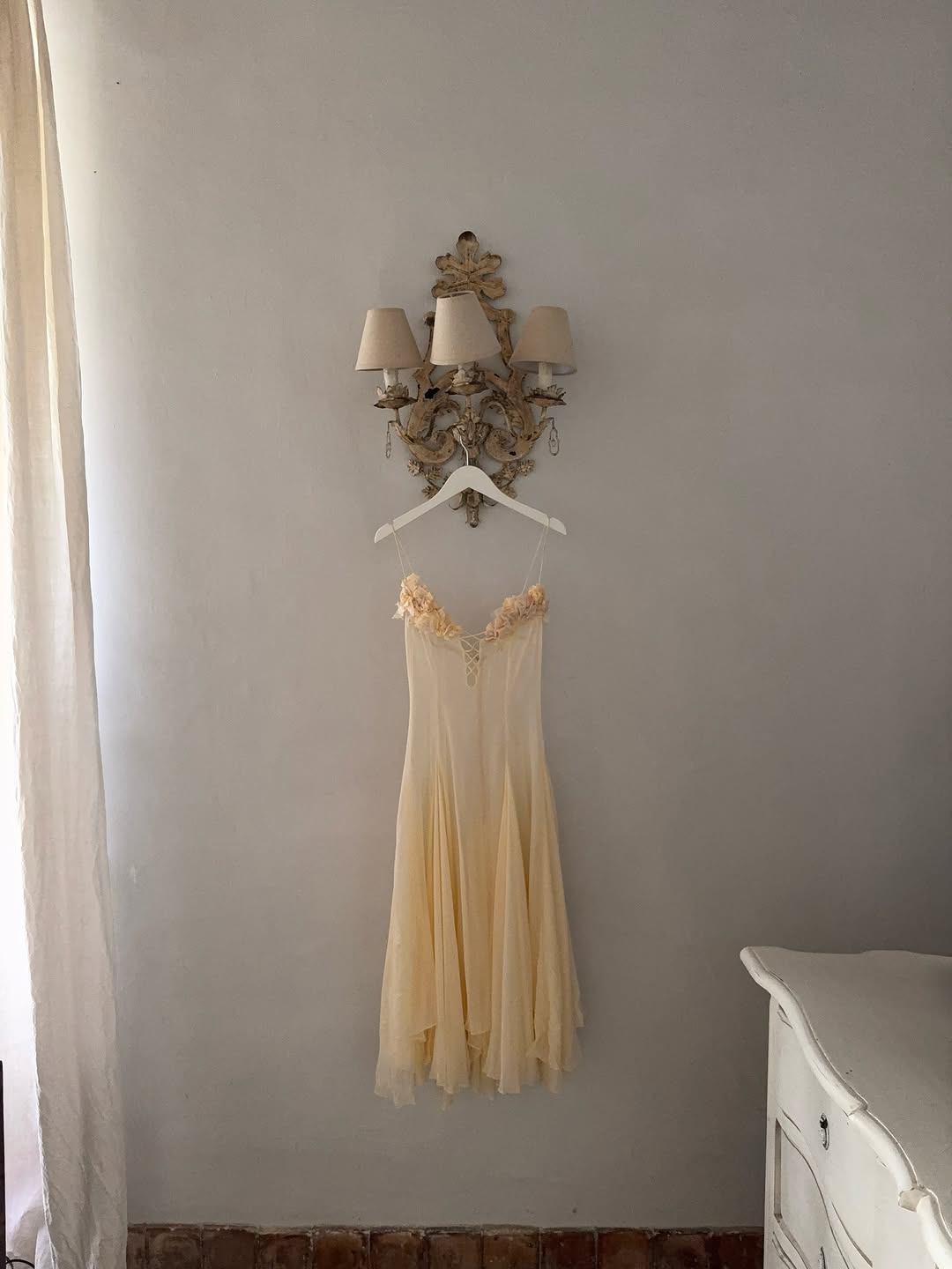 The Valentina Dress is crafted from delicate silk chiffon and features intricately handcrafted floral detailing individually positioned on the bust, creating a uniquely elegant motif. Its 1/8-inch chiffon crisscross straps add refined support and visual interest at the center. Designed with a separate full lining, it offers versatile wear options, either sheer or fully lined. 