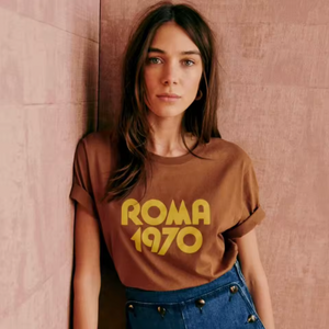 Elevate your casual wardrobe with the Roma 1970 Vintage T-Shirt—crafted from soft, breathable cotton for lasting comfort. Featuring a timeless brown hue and elegant letter-print design, this short-sleeve crewneck offers a relaxed fit that effortlessly blends vintage charm with modern sophistication. Ideal for women seeking understated style with a classic touch.