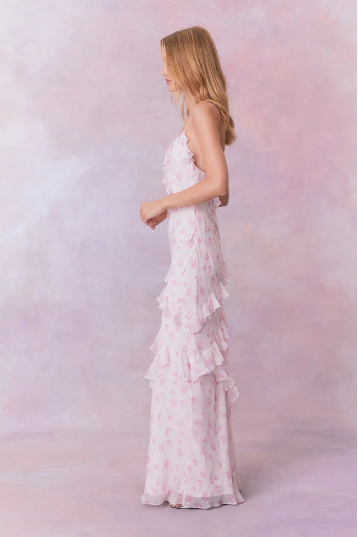 Designed with elegance and movement in mind, the Rialto Maxi Dress in Sterling Dust captivates with its chiffon fabric and cascading asymmetrical ruffles that flow from neckline to hem. Its slightly fitted silhouette enhances your figure with subtle allure, while a discreet side seam zipper ensures a seamless fit. Perfect for dancing or any refined occasion, this dress combines comfort with sophisticated style effortlessly.