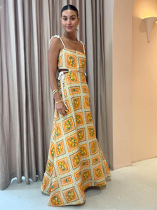 Embrace the essence of a Sicilian summer with the Lemonade Tie Maxi Dress in Orange Mosaic. Made from a breathable linen-cotton blend and fully lined, this dress offers comfort through long summer days. Its straight neckline and fitted bodice flatter the silhouette, while adjustable rope shoulder and waist ties provide a personalized fit. 