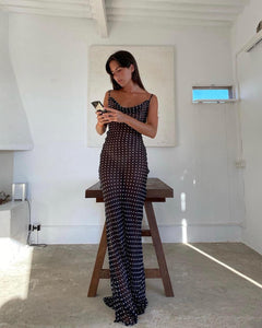 Indulge your inner siren with the Gisele Dress from Rat and Boa. Inspired by 90s fashion, this slip dress is made from sheer polka dot silk, hugging your curves in all the right places. The cowl neck and open back add irresistible charm. Channel your inner goddess in this must-have piece.