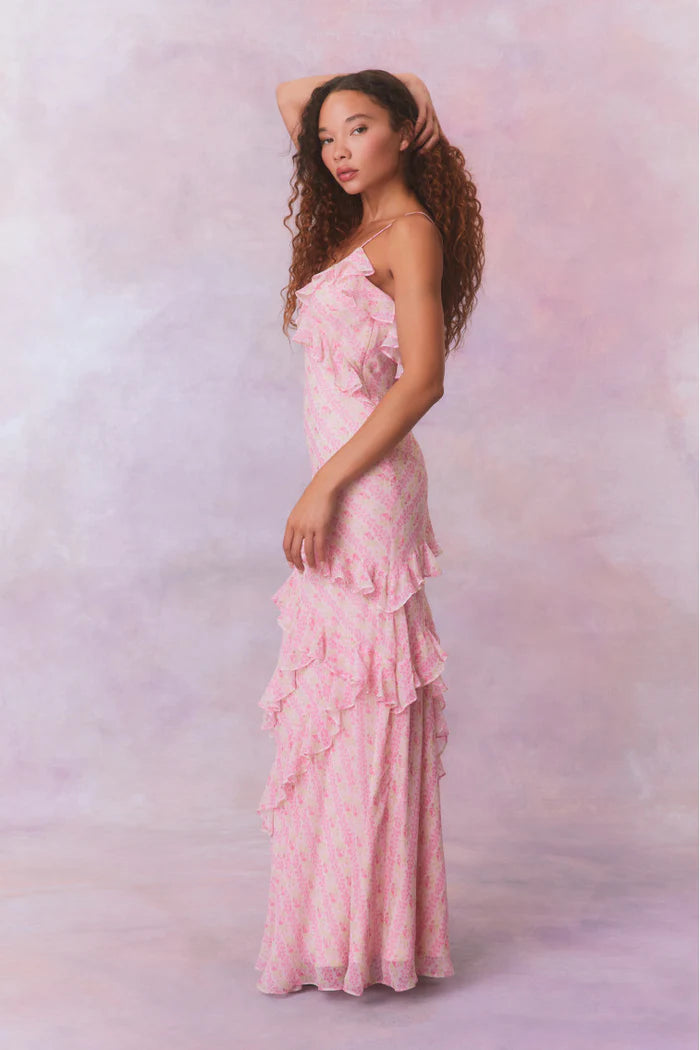 Designed with elegance and movement in mind, the Rialto Maxi Dress in Strawberry Macaroon captivates with its chiffon fabric and cascading asymmetrical ruffles that flow from neckline to hem. Its slightly fitted silhouette enhances your figure with subtle allure, while a discreet side seam zipper ensures a seamless fit. Perfect for dancing or any refined occasion, this dress combines comfort with sophisticated style effortlessly.