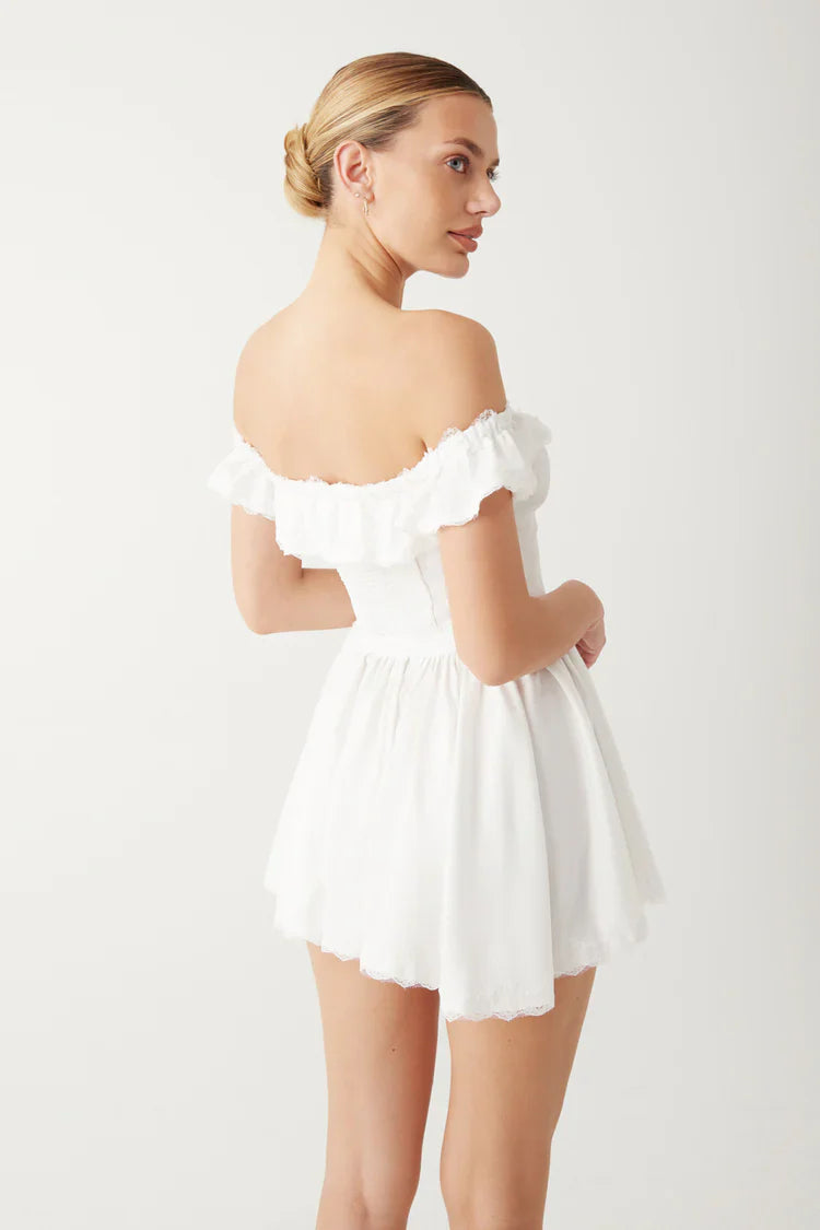 Elevate your evening look with the Charli Mini Dress. Made of silk-like fabric, this off-the-shoulder dress features a smocked back and corset waist for a sultry silhouette. Vintage-inspired lace accents and lace trim add a touch of elegance, while the elastic neckline ensures a comfortable fit. Perfect for any special occasion.