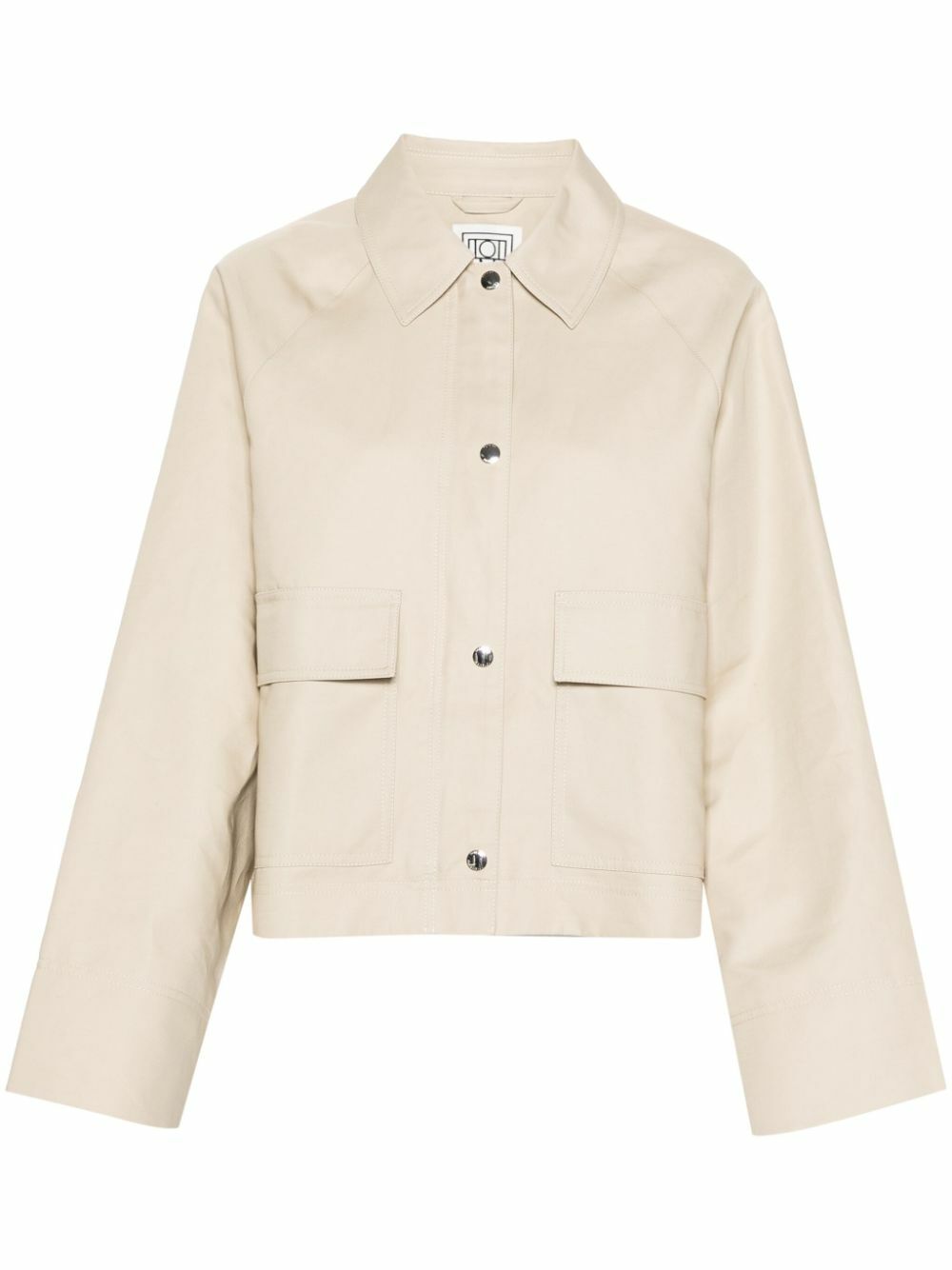 Elevate your wardrobe with this TOTEME organic cotton cropped jacket, crafted from sustainable sand beige canvas. The tailored silhouette features a classic collar, raglan sleeves, and a straight hem for effortless sophistication. Practical front flap pockets and full lining provide everyday functionality, while the dual press-stud and zip fastening offers versatile styling options. A refined essential that transitions seamlessly from casual to polished occasions.