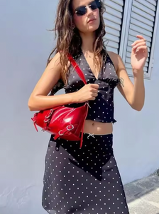 Embrace timeless elegance with the Iris Set, a vintage-inspired two-piece ensemble perfect for summer. Featuring a V-neck halter top paired with a straight skirt, this polka dot outfit blends retro charm with modern sophistication. Ideal for beach outings or stylish daywear, it offers both comfort and grace, ensuring you make a confident statement wherever you go.
