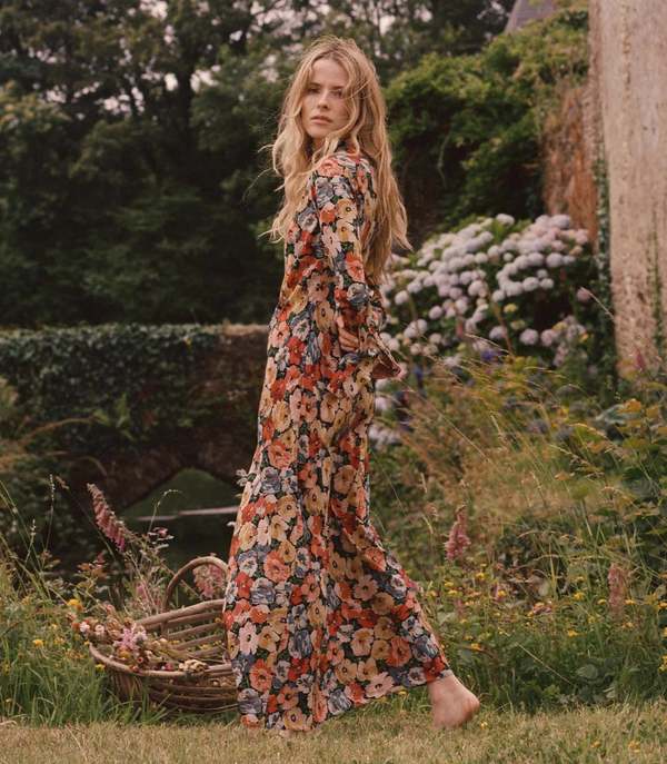 Crafted from washed silk crepe de chine, the Musetta Dress in Poppy Meadow by Doen combines elegance with refined tailoring. It features a sophisticated mock neck and dramatic flared sleeves finished with delicate ruffle trims at the cuffs. The fitted bodice, enhanced by an invisible side zipper, seamlessly flows into an ankle-grazing bias-cut skirt, ensuring a flattering silhouette and graceful movement. Ideal for those seeking timeless style with subtle, expert detailing.