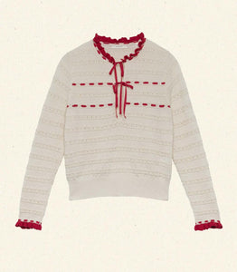 Inspired by 1940s knitwear, the Cordelie Top in Moonstone features a luxurious blend of 80% baby alpaca and 20% silk for exceptional softness and warmth. Lightweight yet insulating, this layerable piece offers delicate sophistication with silk grosgrain ribbons that tie elegantly at the neck. Crafted in Peru with sheer opaque fabric, it combines refined heritage style with modern comfort for versatile wear.