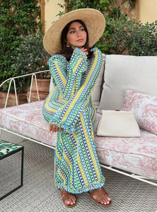 The Isla Maxi Dress is the perfect addition to your summer wardrobe. Crafted with a crochet knit and a stylish open back, this dress offers a fitted silhouette and bell sleeves for a trendy look. Ideal for beach vacations, it's a must-have for any fashion-forward woman.