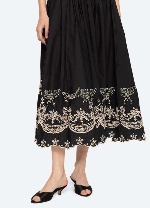 The Kingsley embroidered tank dress by SEA NY showcases intricate embroidery throughout its design, offering a refined and elegant appeal. It features a high neckline that adds a sophisticated touch, complemented by a delicate back bow tie for adjustable fit and added charm. The scalloped hemline enhances the dress's feminine silhouette, making it an exceptional choice for those seeking a polished yet distinctive look.