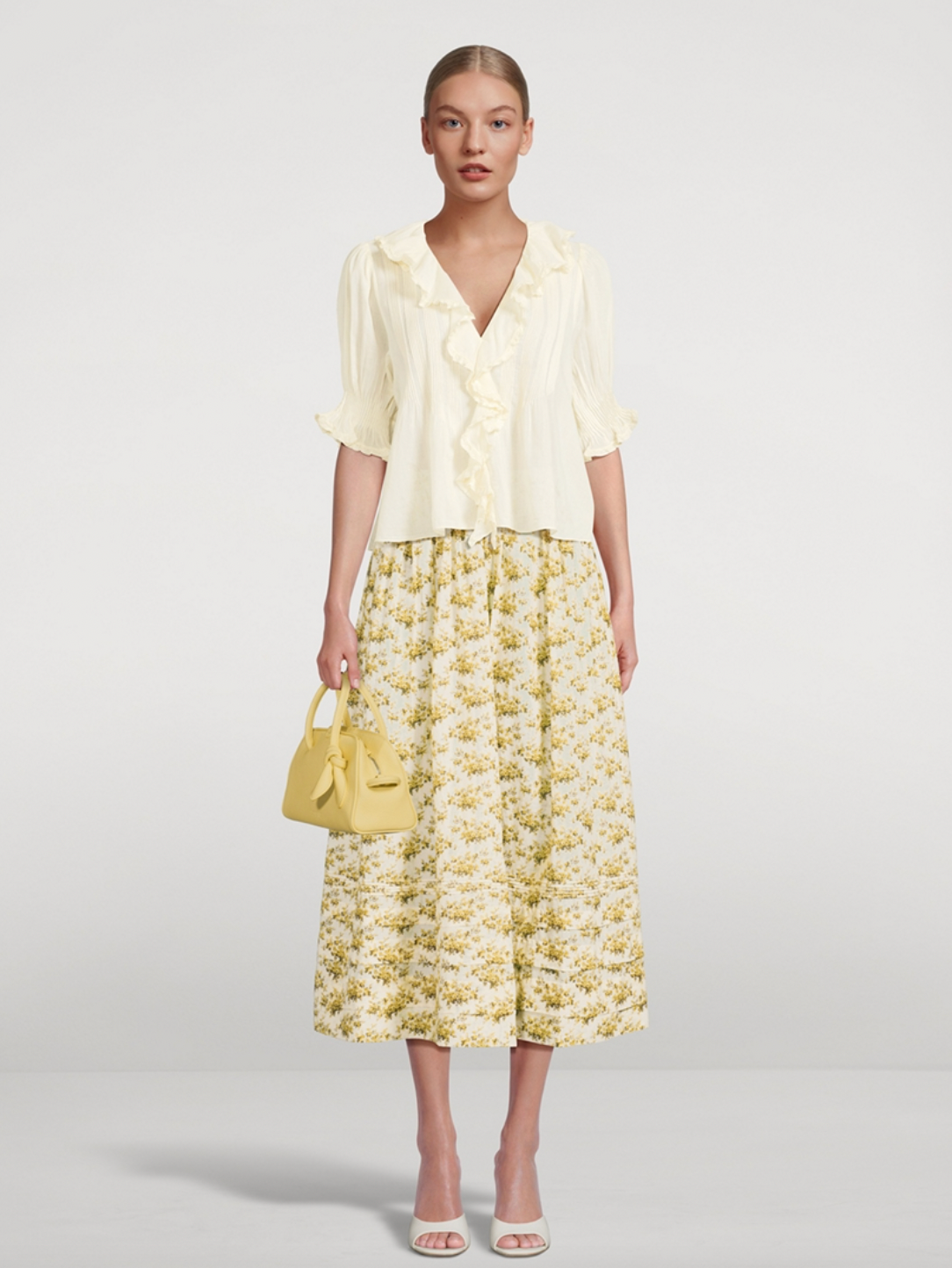 The Marcie Maxi Skirt in Floral Print by Doen is crafted from soft, lightweight organic cotton voile, featuring a Victorian-inspired Rosier Floral design. It boasts a high waist with an invisible side seam zipper, offering a seamless fit. The ankle-grazing full skirt is detailed with elegant pintucks, combining classic style with refined craftsmanship. Certified to the Global Organic Textile Standard, this skirt ensures both quality and sustainability.