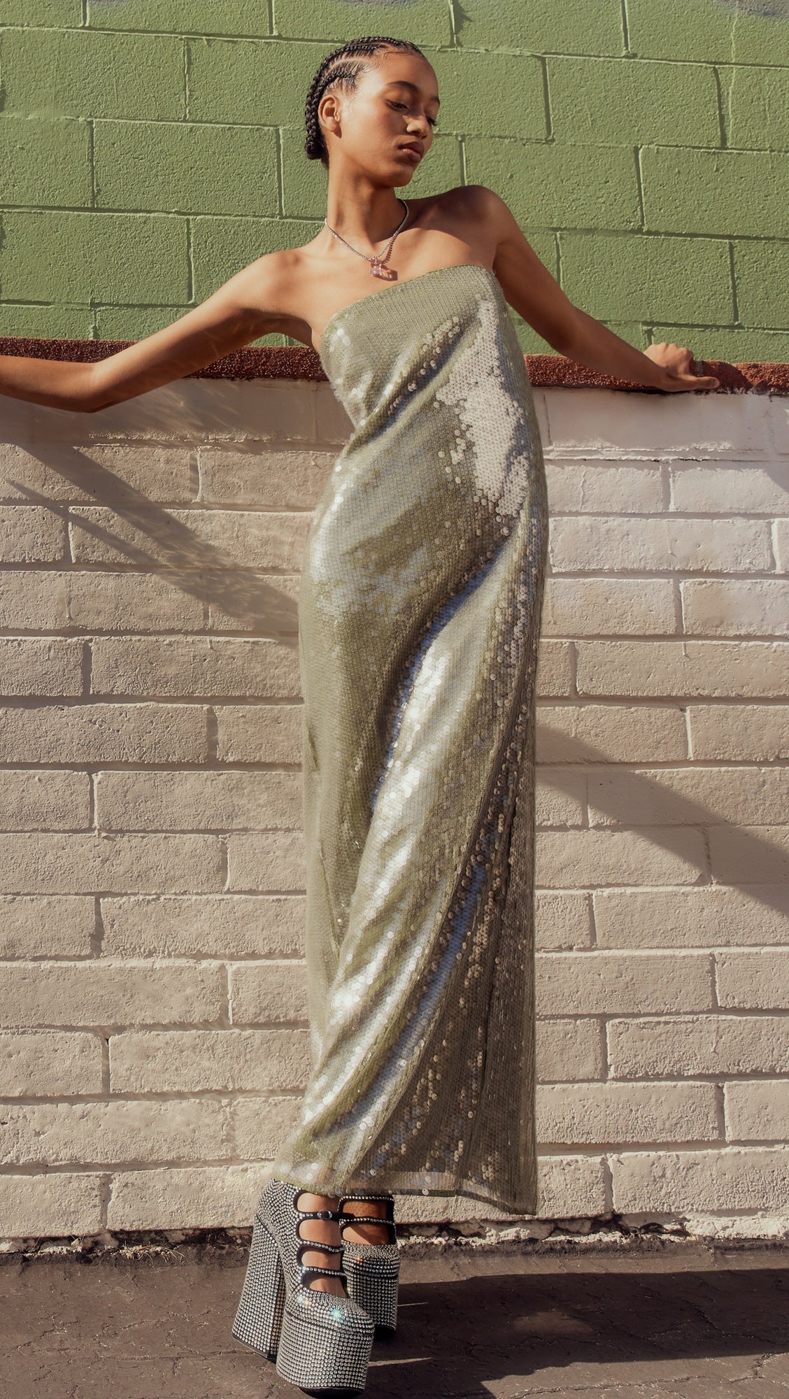 The Casey Dress by Staud combines contemporary elegance with practical sophistication. Crafted from mid-weight mesh, this strapless silhouette features allover iridescent paillette embellishments that catch light beautifully. The non-slip rubber binding ensures a secure fit, while the back slit adds movement and visual interest. Secured with a hidden zip and hook-and-eye closure for a seamless finish.