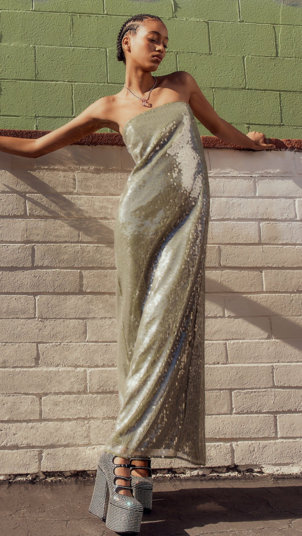 The Casey Dress by Staud combines contemporary elegance with practical sophistication. Crafted from mid-weight mesh, this strapless silhouette features allover iridescent paillette embellishments that catch light beautifully. The non-slip rubber binding ensures a secure fit, while the back slit adds movement and visual interest. Secured with a hidden zip and hook-and-eye closure for a seamless finish.