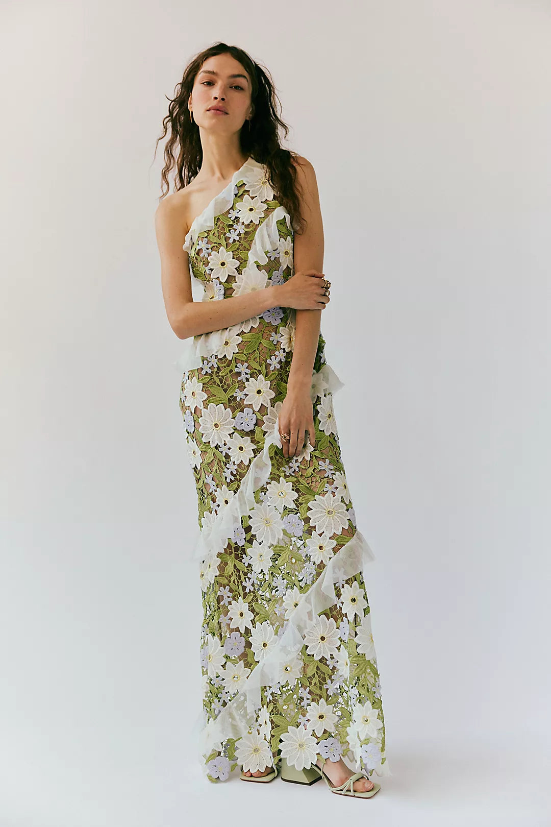 Experience effortless femininity and ethereal beauty in the Flora Maxi Dress. Crafted from delicate embroidered lace, this slim-fitting silhouette boasts an asymmetric neckline and cascading ruffles that add a touch of romance. The flared A-line hem and invisible zipper make for a flattering fit. Perfect for any special occasion!