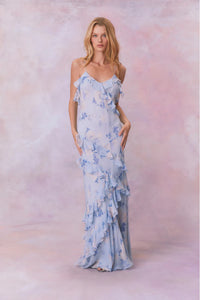 Designed with elegance and movement in mind, the Rialto Maxi Dress in Whisper Blue captivates with its chiffon fabric and cascading asymmetrical ruffles that flow from neckline to hem. Its slightly fitted silhouette enhances your figure with subtle allure, while a discreet side seam zipper ensures a seamless fit. Perfect for dancing or any refined occasion, this dress combines comfort with sophisticated style effortlessly.