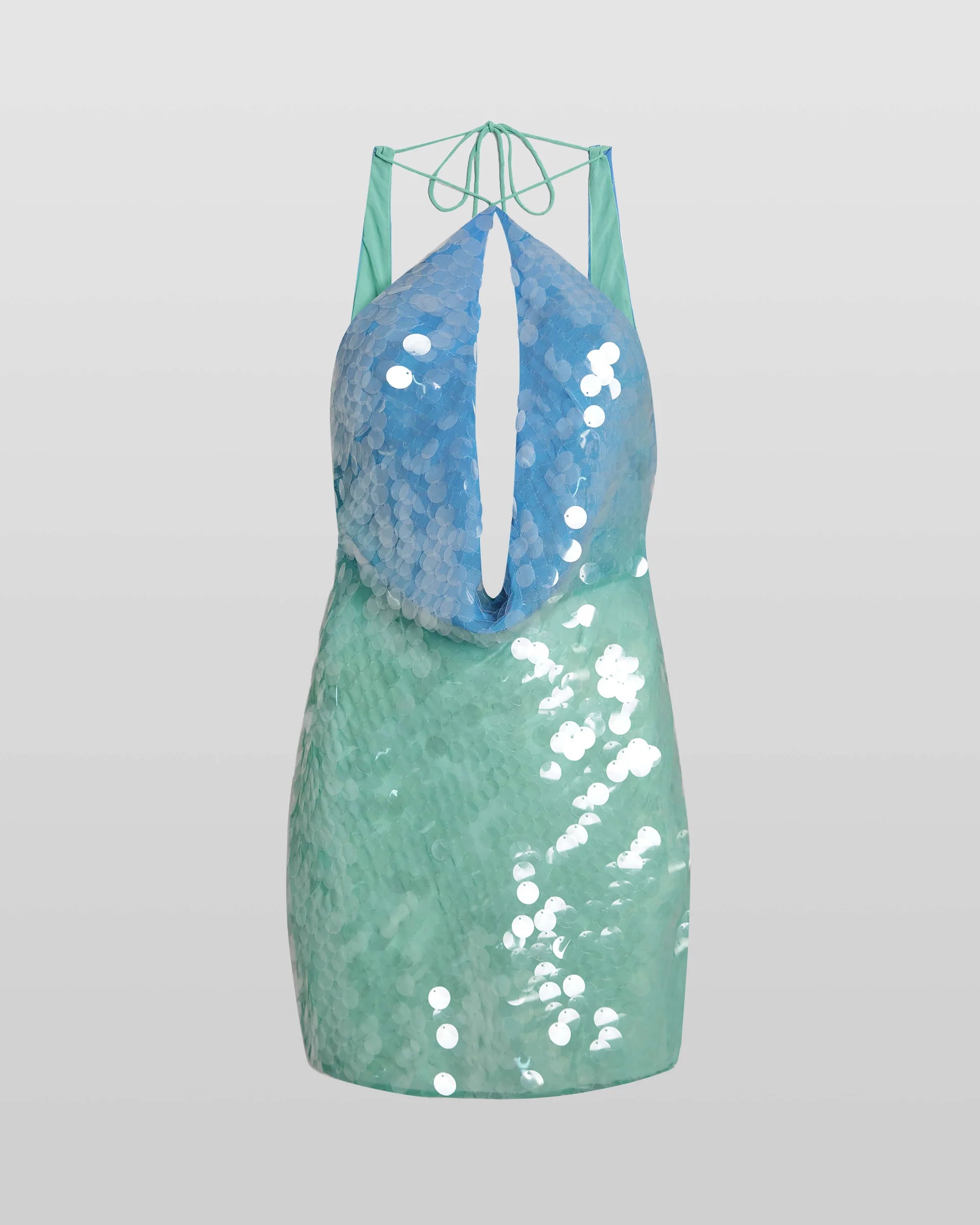 The Kiki Mini Dress dazzles with a molten sequin design that shifts in an ombré gradient from blue to green, capturing light with every movement. Its slinky silhouette is ideal for summer evenings, enhanced by a daring plunge back and an extreme cowl neckline that together create a strikingly sensual appeal. Perfect for making a bold statement at any night event.