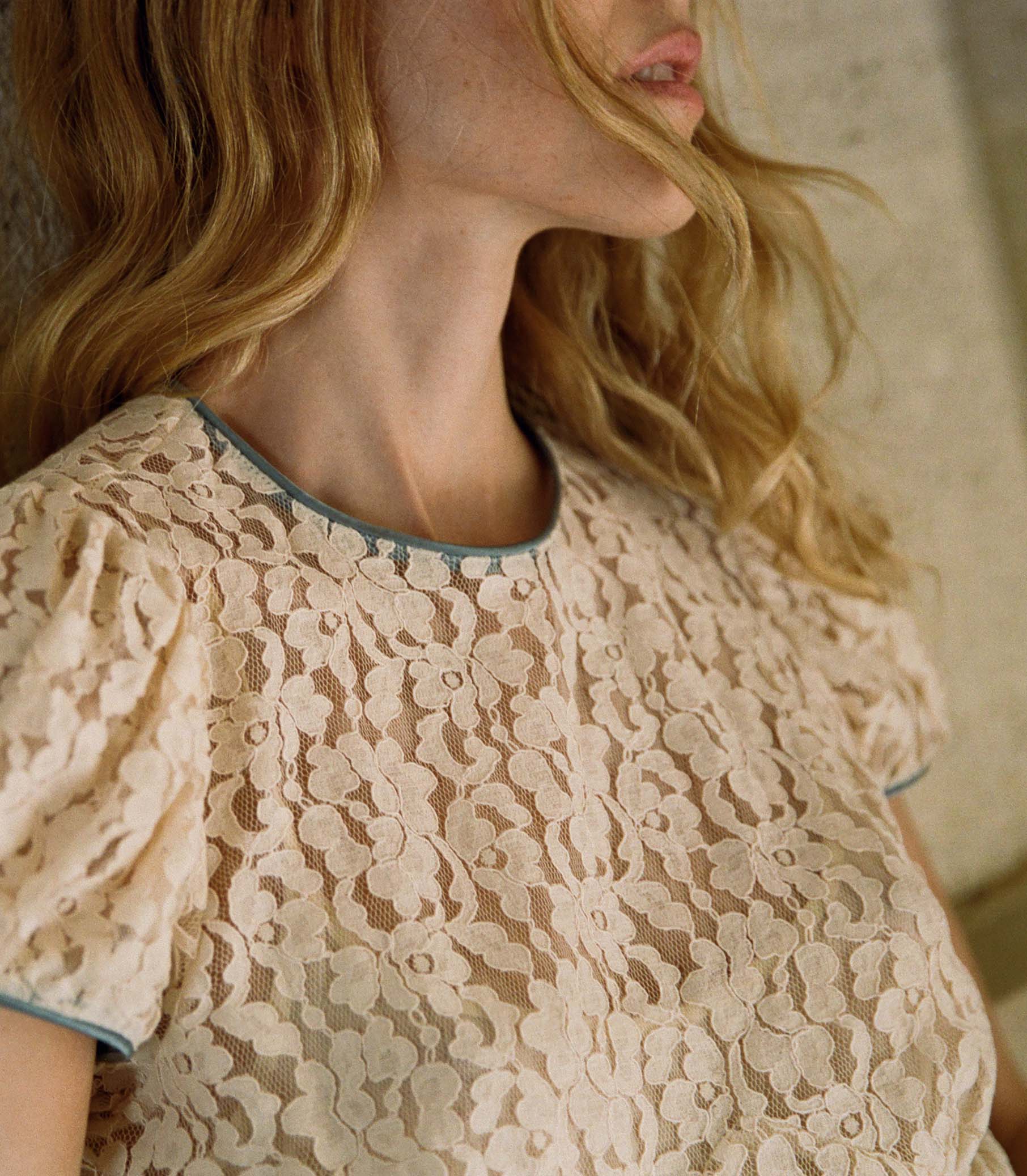 The Katarina Dress by Doen features a refined silhouette crafted from delicate corded lace, enhanced with satin trims along the neckline and puffed sleeves. Designed with a full lining, it offers both elegance and assured coverage, making it a sophisticated choice for special occasions.