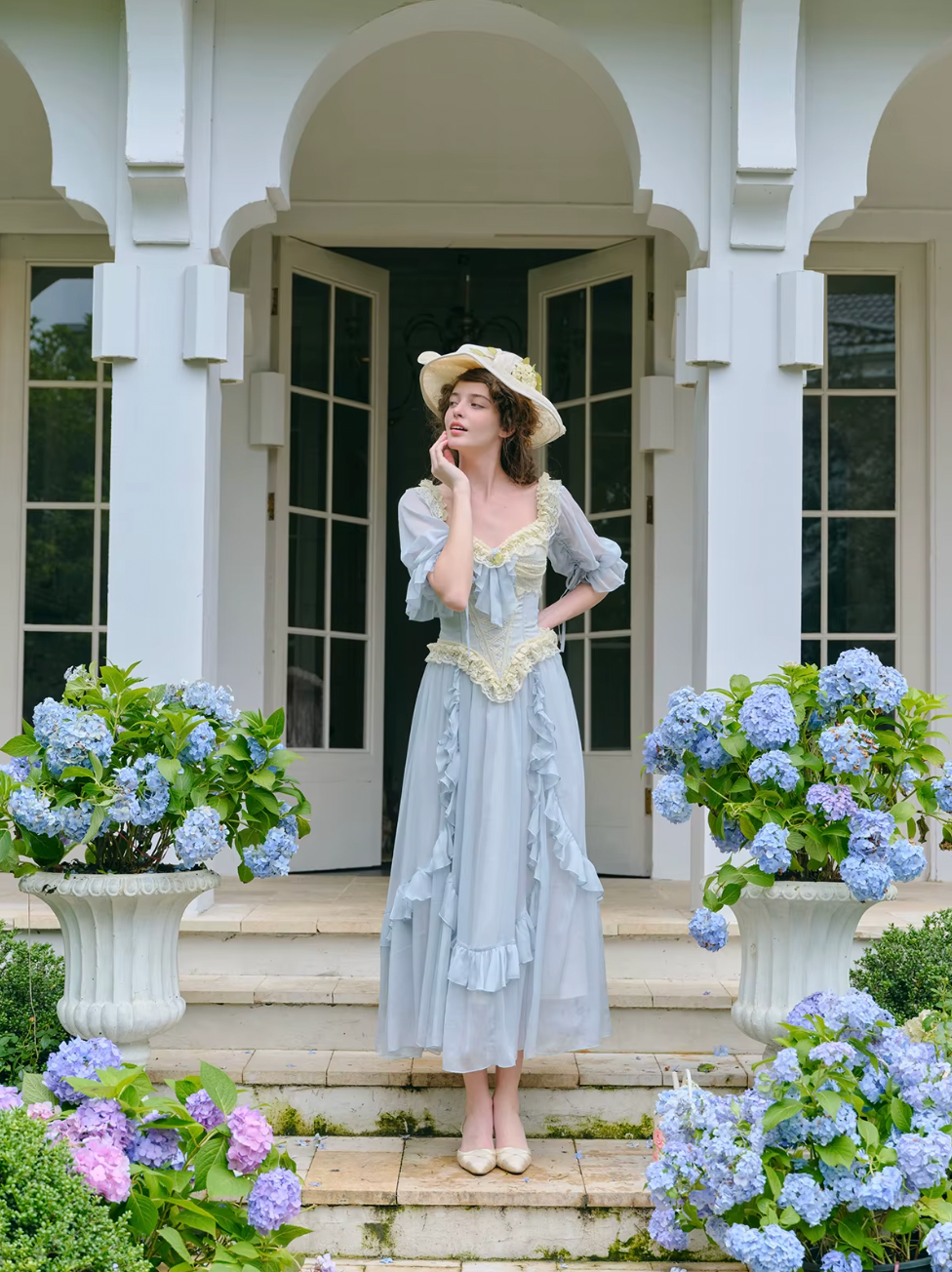 Introducing the Elora Dress - a vintage-inspired, slimming maxi dress in a sophisticated fishbone blue. With delicate lace accents and a seductive V-neck, this dress is perfect for summer parties and birthdays. Channel elegance and sexiness with every step in this exclusive piece.
