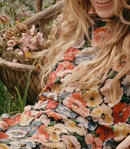 Crafted from washed silk crepe de chine, the Musetta Dress in Poppy Meadow by Doen combines elegance with refined tailoring. It features a sophisticated mock neck and dramatic flared sleeves finished with delicate ruffle trims at the cuffs. The fitted bodice, enhanced by an invisible side zipper, seamlessly flows into an ankle-grazing bias-cut skirt, ensuring a flattering silhouette and graceful movement. Ideal for those seeking timeless style with subtle, expert detailing.