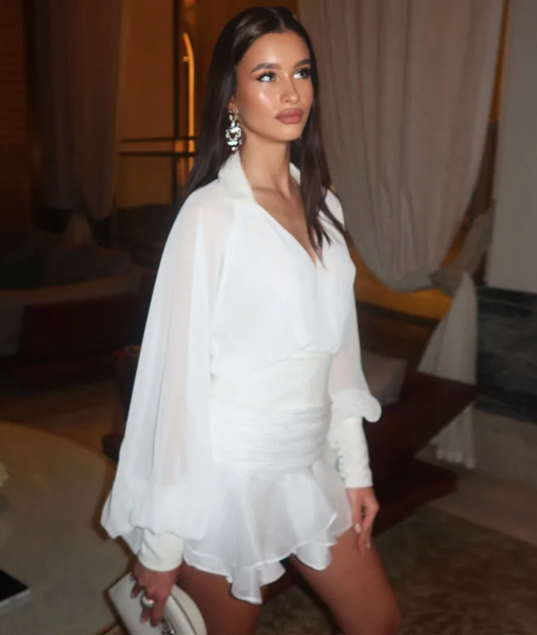 Elevate your wardrobe with the Melrose Shirt Dress, a refined dress featuring a backless blouse with a matching mini skirt. The blouse highlights a V-neckline and long lantern sleeves, adding a delicate yet striking touch. The accompanying A-line skirt offers a flattering silhouette, perfect for both day and evening occasions. This ensemble blends modern elegance with timeless charm, making it a sophisticated choice for confident women.