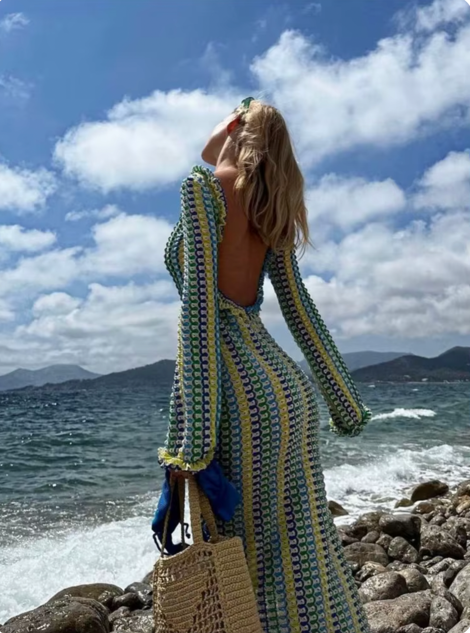 The Isla Maxi Dress is the perfect addition to your summer wardrobe. Crafted with a crochet knit and a stylish open back, this dress offers a fitted silhouette and bell sleeves for a trendy look. Ideal for beach vacations, it's a must-have for any fashion-forward woman.