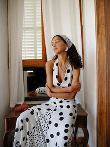 The Maria Dress offers a refined summer silhouette with its sleeveless halter design and delicate dot print. Featuring a lace-up back that creates an elegant backless effect, this maxi dress balances allure with comfort. Lightweight, flowing fabric ensures ease of movement, making it an ideal choice for warm evenings or vacation settings. Its thoughtful construction combines style and practicality, guaranteeing a standout presence in any occasion.