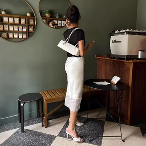 Elevate your wardrobe with the Margot Lace Skirt, an elegant satin piece designed for the modern professional woman. Featuring a high waist and graceful lace splice detail, this long skirt combines sophistication with comfort, ideal for summer wear. Its refined silhouette enhances your figure while maintaining a polished look suitable for any formal or business setting. The breathable satin fabric ensures all-day comfort, making it a versatile addition to your seasonal collection.