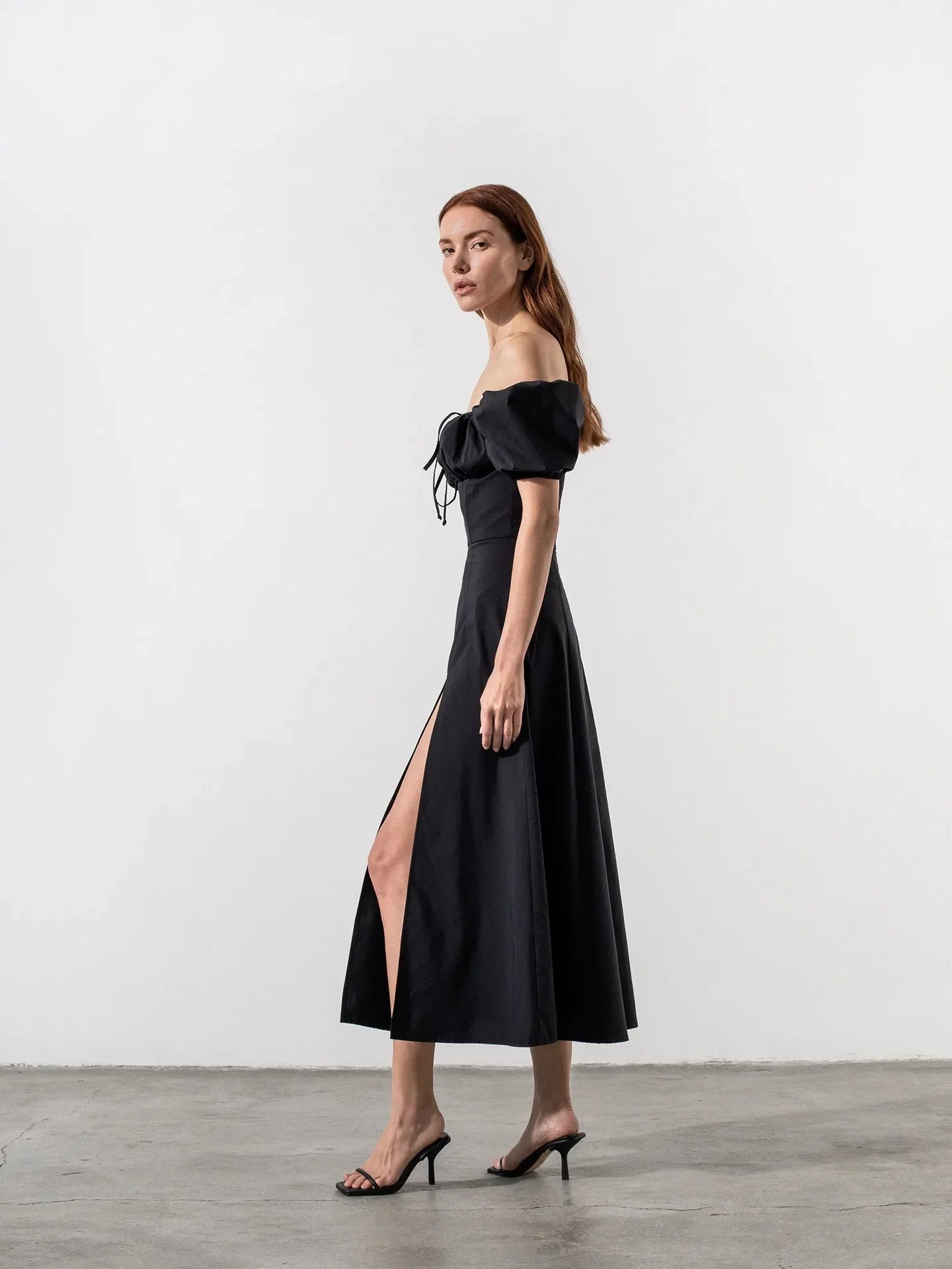 Discover the perfect blend of French elegance and vacation vibes with our Lea Midi Dress. Made with high-end, black fabric, this dress features puffy sleeves and a side slit that will make you the best dressed this summer. Don't miss out on this best-selling dress for any occasion.