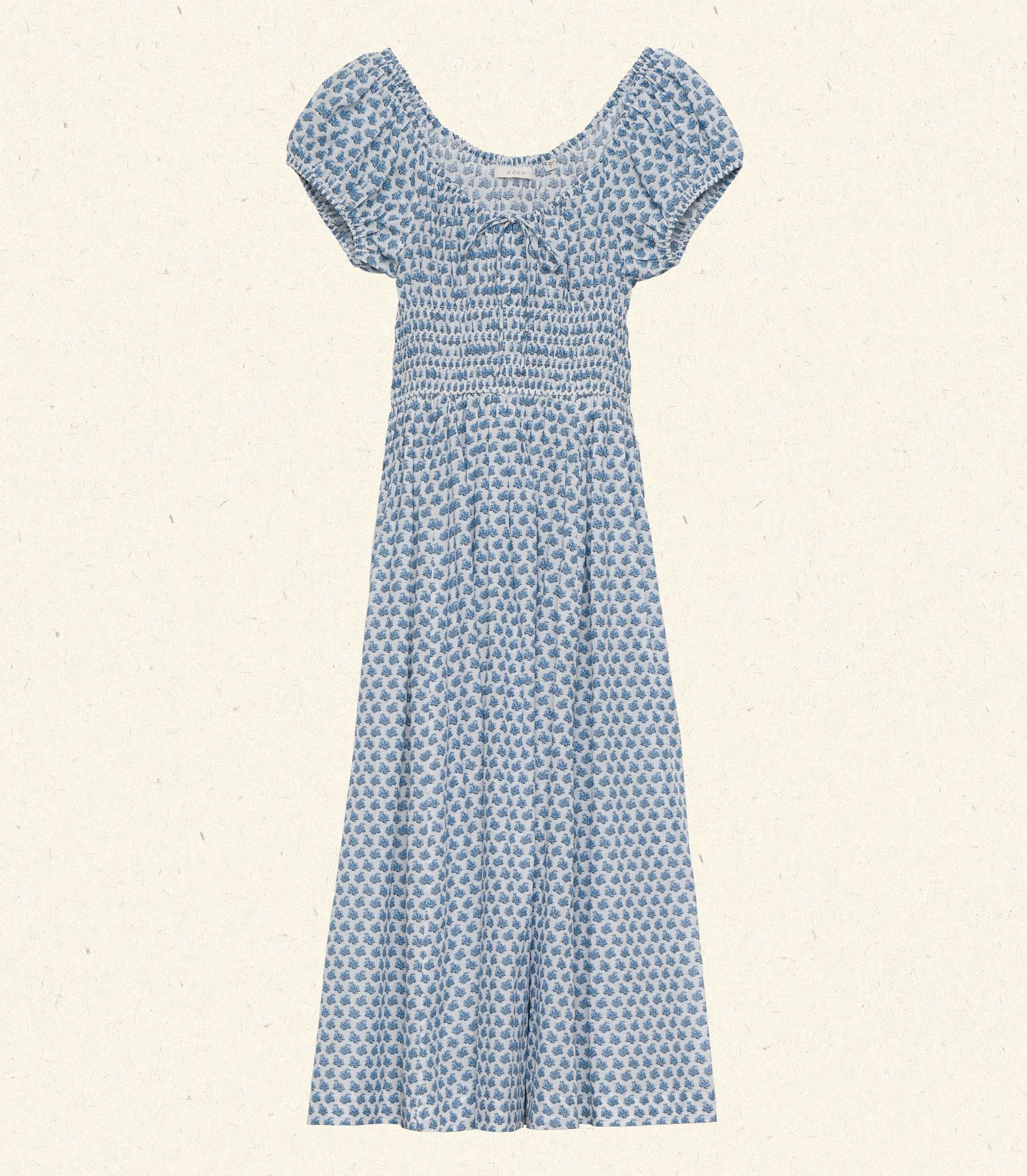 Crafted from 100% organic cotton poplin, the Quinn Dress in Dahlia Ditsy by DOEN offers refined comfort with a scoop neckline accented by an adjustable tie and an elegant keyhole detail, creating a graceful silhouette perfect for any occasion.