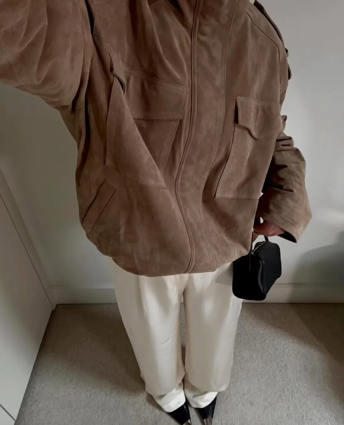 This Suede Jacket combines timeless sophistication with practical design. Crafted from soft suede leather, it features a high collar that provides extra warmth and a refined look. Long cuffed sleeves with shoulder tabs enhance its rugged appeal, while front and chest flap pockets offer convenient storage without sacrificing style. 