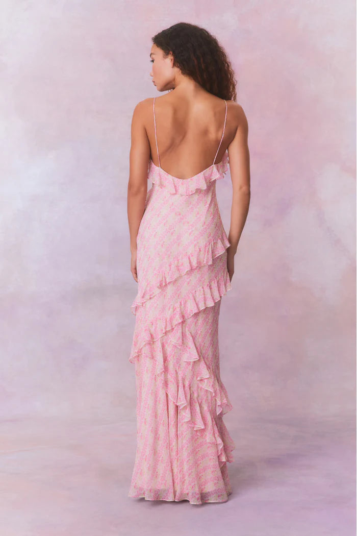 Designed with elegance and movement in mind, the Rialto Maxi Dress in Strawberry Macaroon captivates with its chiffon fabric and cascading asymmetrical ruffles that flow from neckline to hem. Its slightly fitted silhouette enhances your figure with subtle allure, while a discreet side seam zipper ensures a seamless fit. Perfect for dancing or any refined occasion, this dress combines comfort with sophisticated style effortlessly.