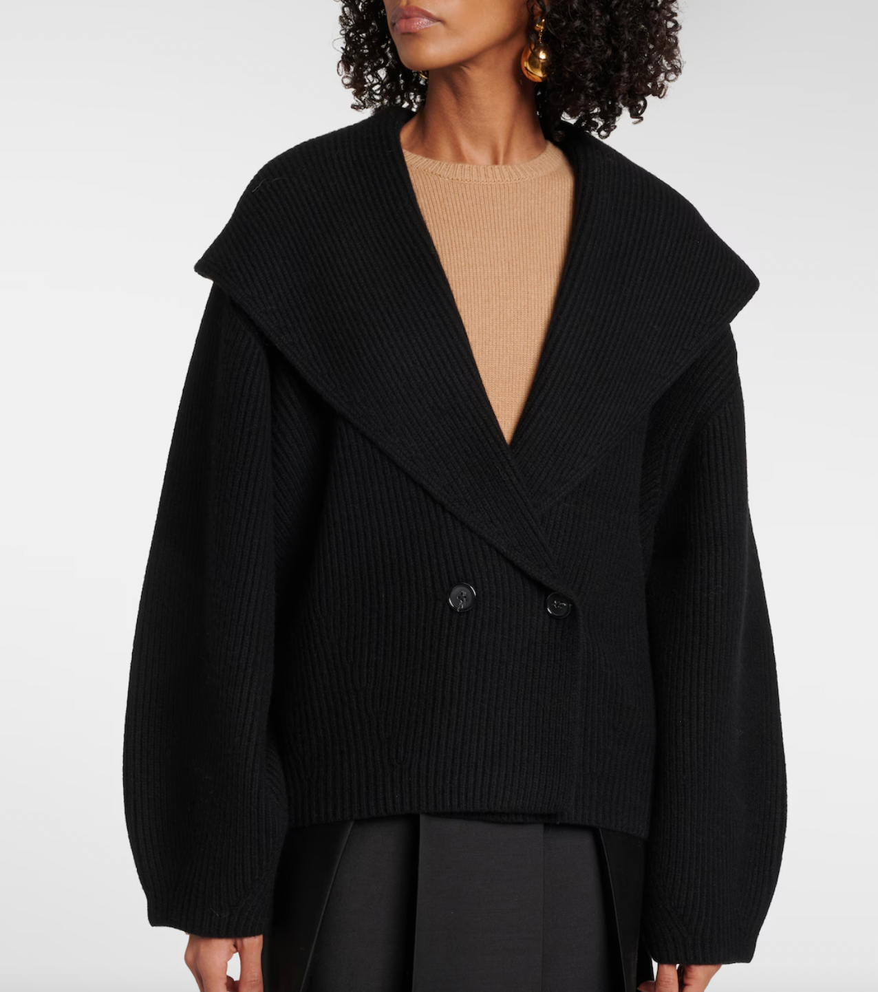 This Toteme wool-blend cardigan offers refined warmth and timeless style. Crafted from a premium wool blend, it provides softness and insulation perfect for layering in cooler weather. Its clean lines and subtle detailing ensure a versatile piece suitable for both casual and more polished looks, making it a valuable addition to any discerning wardrobe.