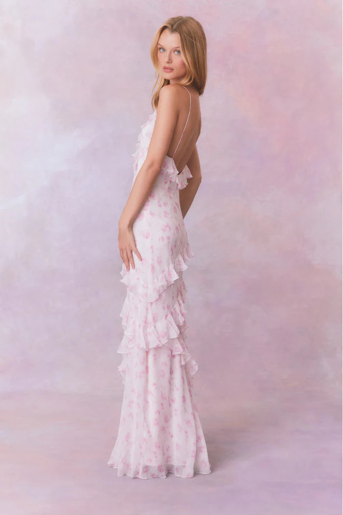 Designed with elegance and movement in mind, the Rialto Maxi Dress in Sterling Dust captivates with its chiffon fabric and cascading asymmetrical ruffles that flow from neckline to hem. Its slightly fitted silhouette enhances your figure with subtle allure, while a discreet side seam zipper ensures a seamless fit. Perfect for dancing or any refined occasion, this dress combines comfort with sophisticated style effortlessly.
