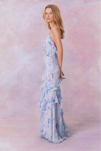 Designed with elegance and movement in mind, the Rialto Maxi Dress in Whisper Blue captivates with its chiffon fabric and cascading asymmetrical ruffles that flow from neckline to hem. Its slightly fitted silhouette enhances your figure with subtle allure, while a discreet side seam zipper ensures a seamless fit. Perfect for dancing or any refined occasion, this dress combines comfort with sophisticated style effortlessly.