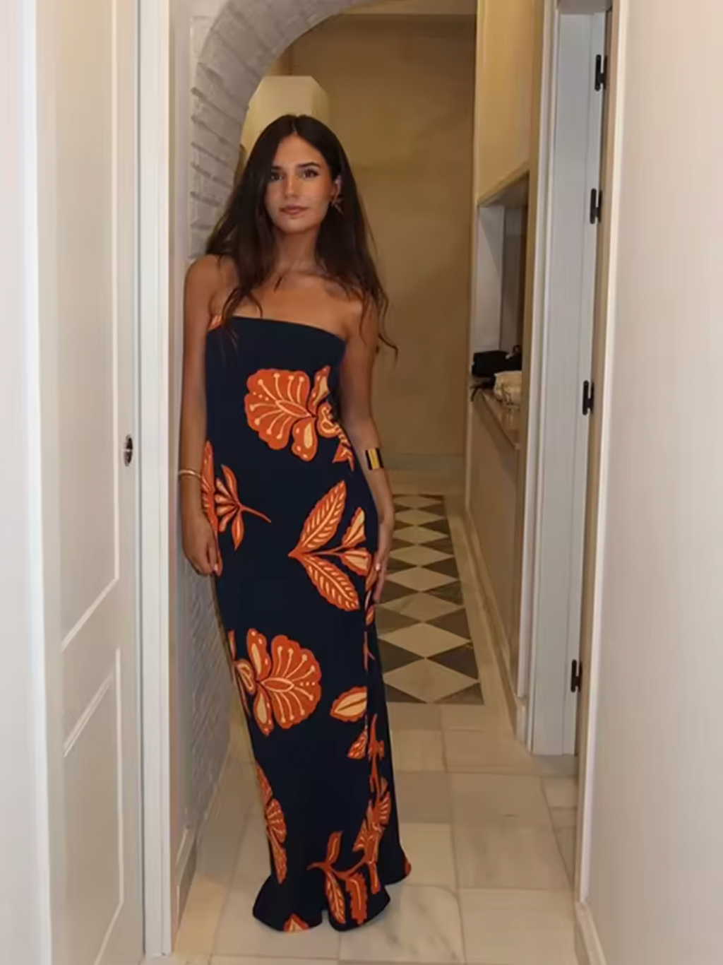 Embrace elegance with the Orfila Manila Maxi Dress, featuring a strapless floral print that captures the essence of summer sophistication. Its sleeveless, backless design paired with a flowing silhouette offers a flattering, graceful fit perfect for beach parties or evening events. Complete with a coordinating scarf, this dress combines comfort and style for unforgettable holiday moments.