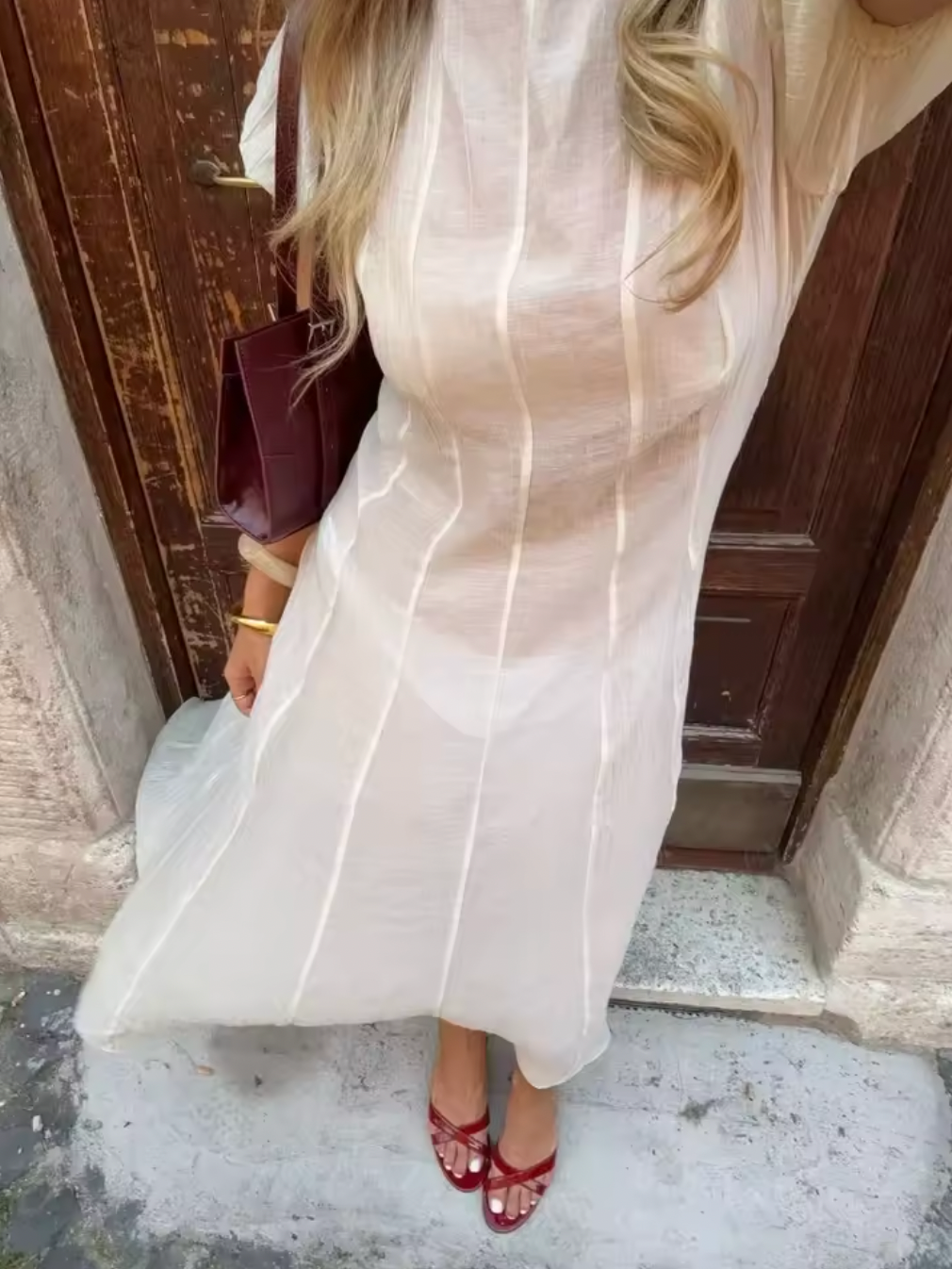 The Emory Dress features delicate chiffon fabric with elegant puff sleeves and elastic cuffs, creating a romantic silhouette. Its unlined, sheer design reveals undergarments, enhancing its ethereal appeal—please note undergarments are not included. A discreet back zip closure ensures a smooth fit, while hand wash care maintains the dress's lightweight texture and shape. Ideal for those seeking a sophisticated statement piece with a modern, airy feel.