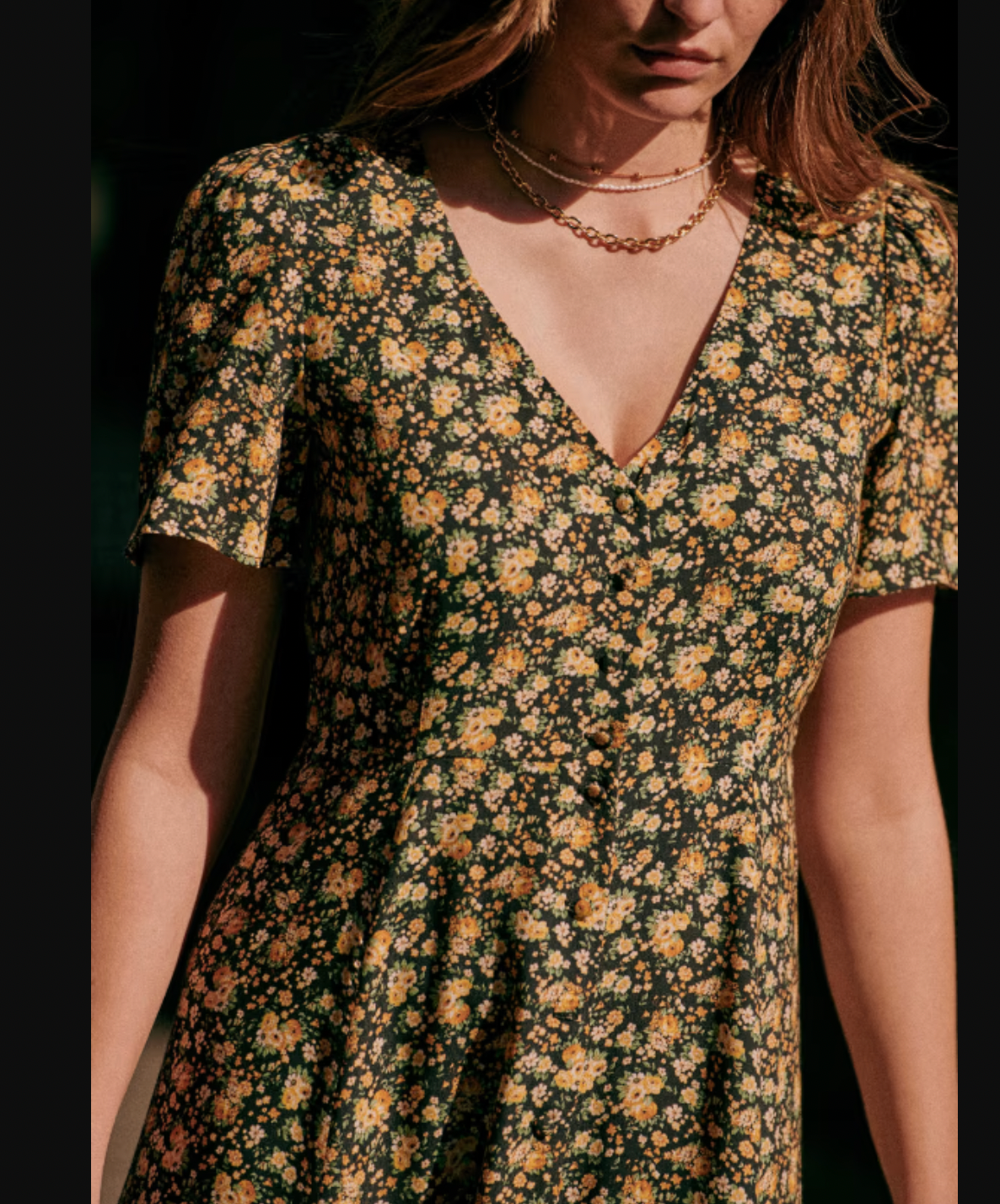 The Vivienne Dress by Sezane offers a graceful midi length silhouette with elegant short sleeves and a refined V neckline. Its button placket features covered buttons, adding a subtle yet polished touch. Fully lined for comfort and quality, this dress embodies sophisticated charm ideal for both formal and special occasions.
