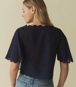 Indulge in the romantic charm of the Kacy Embroidered Top by DOEN, crafted with 100% organic cotton voile and adorned with delicate bow embroidery and playful cutouts. Inspired by vintage Victorian blouses, this top features elegant scalloped details and breezy sleeves that add a touch of sophistication. Elevate your wardrobe with this luxurious and exclusive piece.