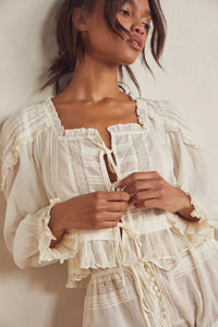 Embrace timeless elegance with the Florence Bed Jacket Set, designed for sophisticated comfort. The structured bed jacket features front tie closures, pleated details, banded trumpet sleeves, and delicate embroidery, offering a refined vintage appeal. Coordinating button-front shorts include a drawstring waist, ruffle trimming, pleated accents, and an embroidered curved hem, ensuring an effortless, flattering fit. This set blends classic style with ease, perfect for lounging with grace and poise.