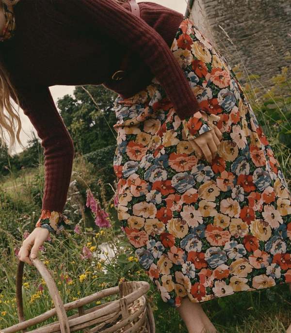 Crafted from washed silk crepe de chine, the Musetta Dress in Poppy Meadow by Doen combines elegance with refined tailoring. It features a sophisticated mock neck and dramatic flared sleeves finished with delicate ruffle trims at the cuffs. The fitted bodice, enhanced by an invisible side zipper, seamlessly flows into an ankle-grazing bias-cut skirt, ensuring a flattering silhouette and graceful movement. Ideal for those seeking timeless style with subtle, expert detailing.