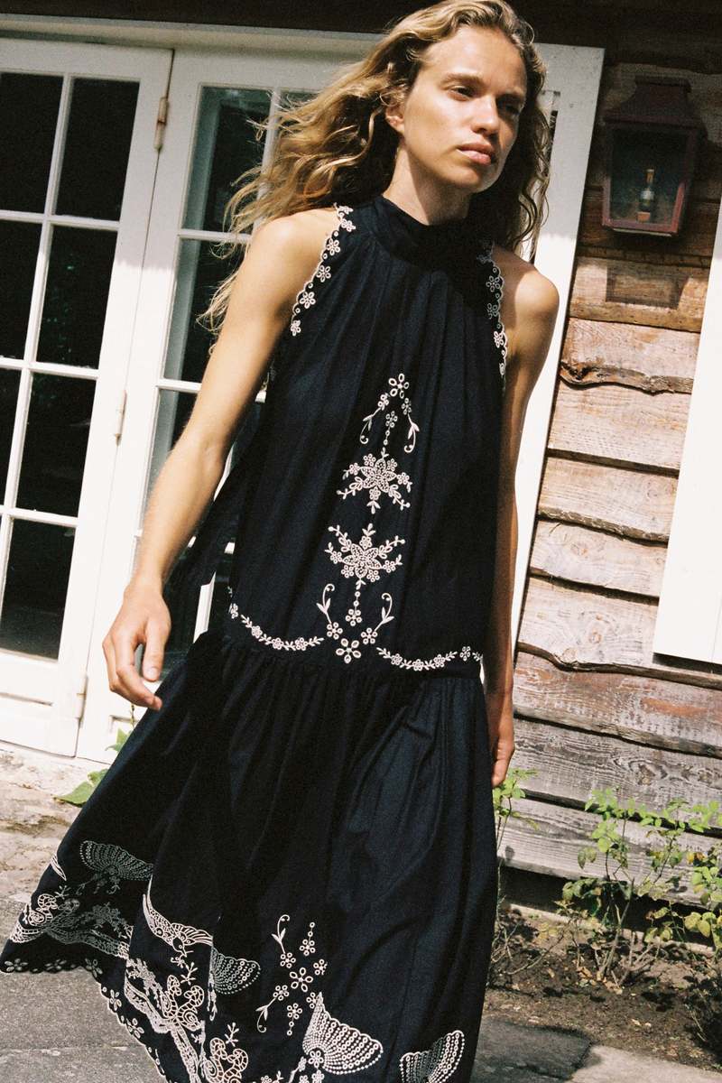 The Kingsley embroidered tank dress by SEA NY showcases intricate embroidery throughout its design, offering a refined and elegant appeal. It features a high neckline that adds a sophisticated touch, complemented by a delicate back bow tie for adjustable fit and added charm. The scalloped hemline enhances the dress's feminine silhouette, making it an exceptional choice for those seeking a polished yet distinctive look.