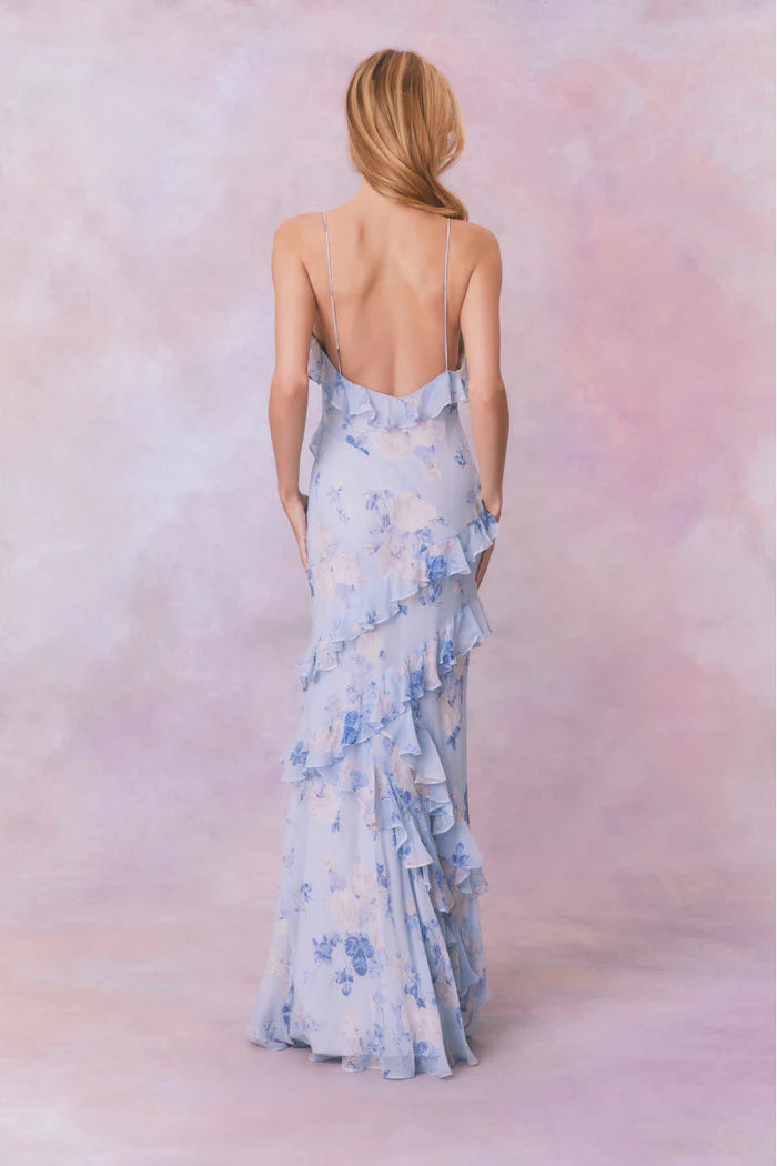 Designed with elegance and movement in mind, the Rialto Maxi Dress in Whisper Blue captivates with its chiffon fabric and cascading asymmetrical ruffles that flow from neckline to hem. Its slightly fitted silhouette enhances your figure with subtle allure, while a discreet side seam zipper ensures a seamless fit. Perfect for dancing or any refined occasion, this dress combines comfort with sophisticated style effortlessly.