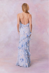 Designed with elegance and movement in mind, the Rialto Maxi Dress in Whisper Blue captivates with its chiffon fabric and cascading asymmetrical ruffles that flow from neckline to hem. Its slightly fitted silhouette enhances your figure with subtle allure, while a discreet side seam zipper ensures a seamless fit. Perfect for dancing or any refined occasion, this dress combines comfort with sophisticated style effortlessly.