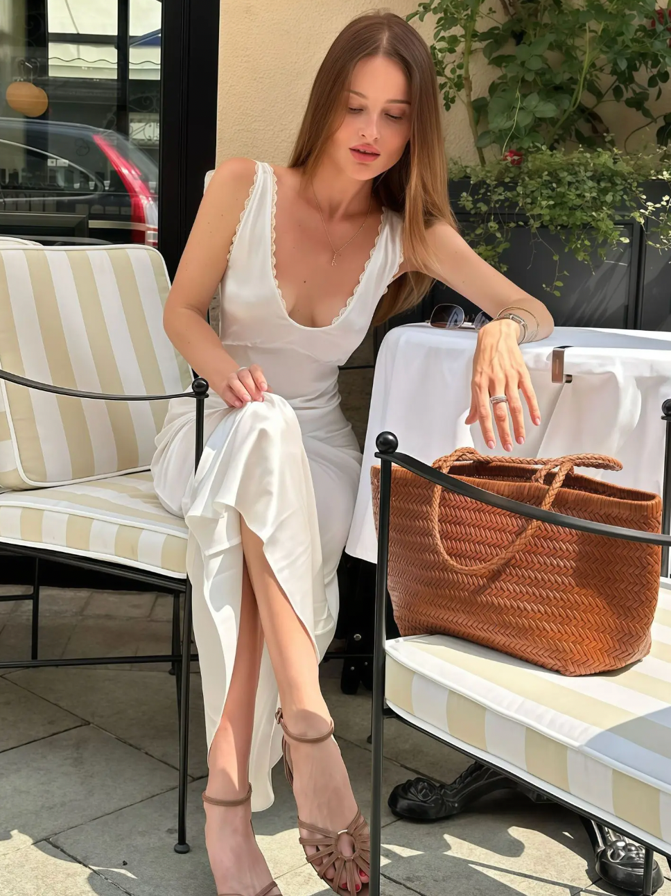 Elevate your evening look with the Allegra Satin Dress, a sleeveless, slim-fit gown designed to flatter your silhouette. Crafted from smooth satin, it features an elegant lace V-neckline and a high waist that enhances your figure. Perfect for sophisticated parties and special occasions, this dress combines timeless style with a touch of sensuality for a truly captivating presence.