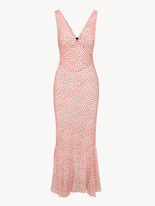 The Zoë in Jazz Devoré by Realisation Par embodies effortless summer elegance with its soft blush pink fabric and delicate red velvet polka dot pattern. This lightweight, sheer dress includes a removable underslip for customizable coverage. Expertly crafted with a plunging V-neckline, a sculpting panelled waist, and a fluted skirt, it flatters the figure while allowing graceful movement. 