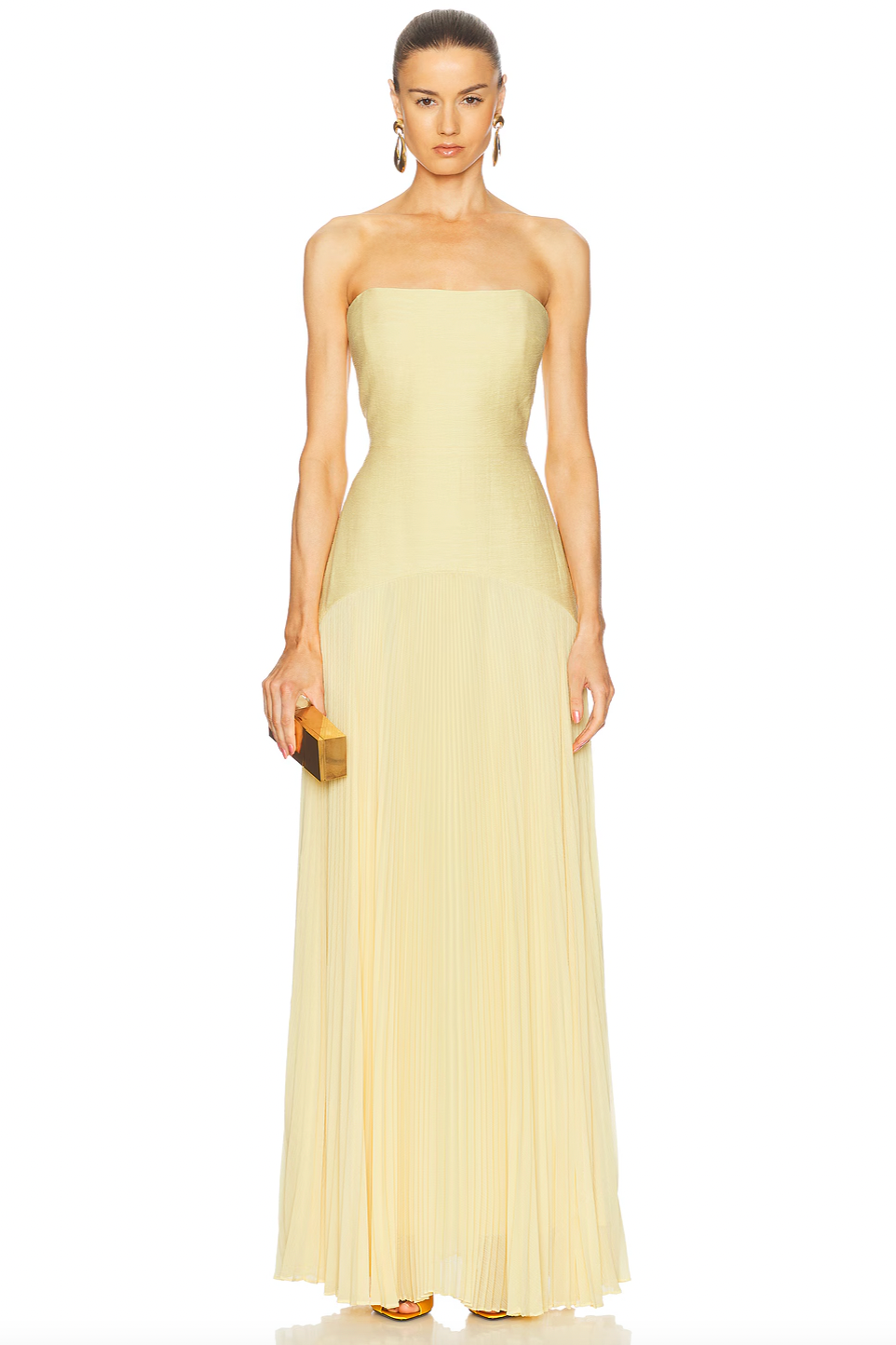 The Sunniva Dress features a fitted strapless bodice and a gracefully curved dropped waist that flows into a delicate plissé skirt. This elegant silhouette accentuates your figure while allowing ease of movement. Ideal for pairing with bold statement earrings, it creates a refined and modern look perfect for leaving a lasting impression at any event.