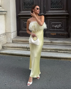 Crafted from smooth satin, this strapless dress features delicate feather detailing that adds an elegant, textured dimension. Its structured bodice provides a flattering fit while maintaining comfort and support. Ideal for formal occasions, the dress offers a refined silhouette that balances sophistication with subtle drama, making it a standout choice for evening events or special celebrations.
