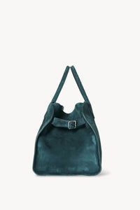 Gracefully structured top handle bag from The Row, crafted in soft calfskin suede with belted, gusseted side panels and a sleek interior.