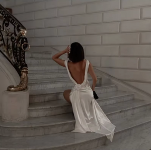 Indulge in luxury with the Darling Gown by DATT. Made from sumptuous silk, this gown exudes elegance. The back split adds a touch of allure while the intricate 3D rose embellishment elevates the design to a work of art. Perfect for those seeking a sophisticated and exclusive piece for their wardrobe.